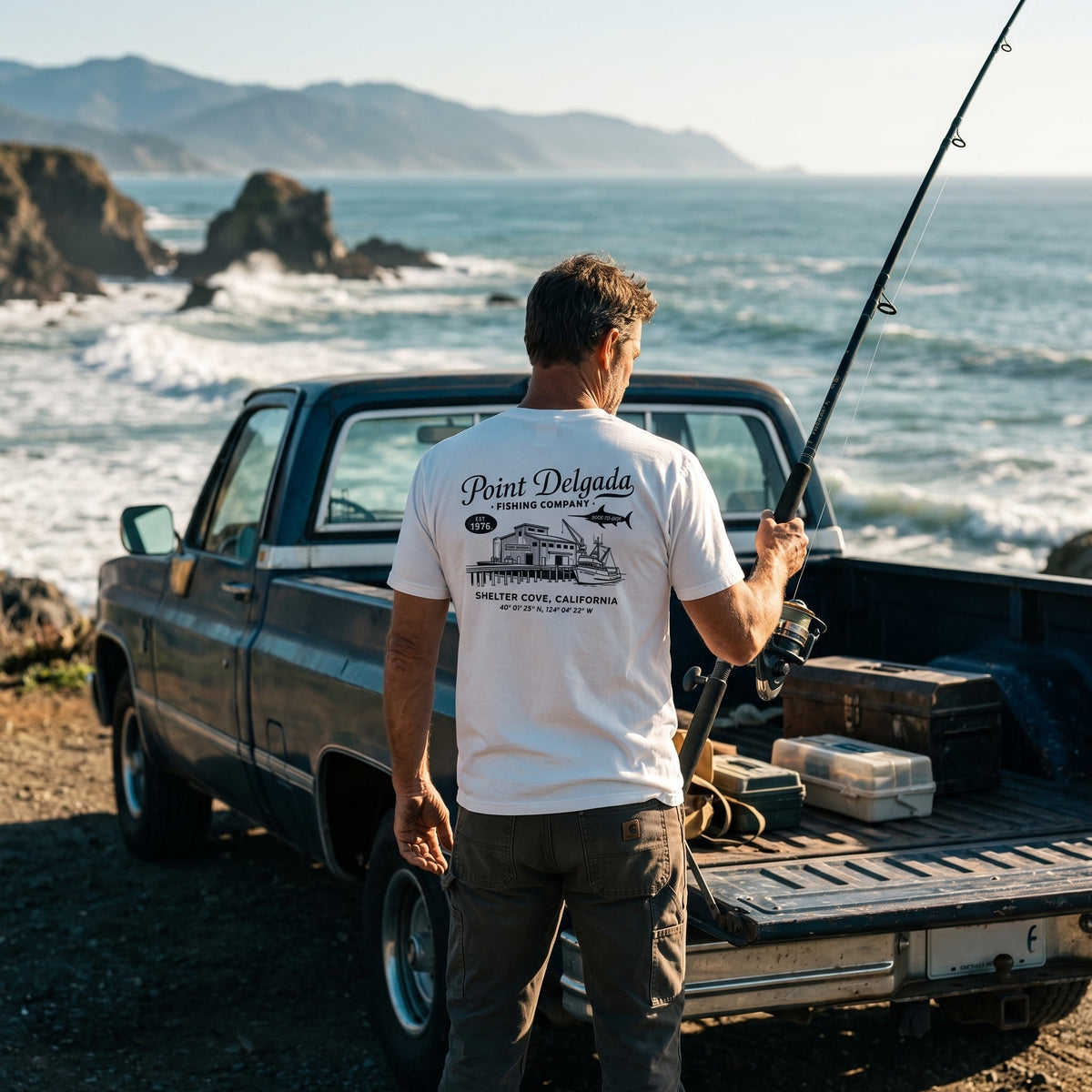 Back: White Point Delgada Home Port T-Shirt with black fish house, pier, fishing boat and Shelter Cove, California coordinates graphic
