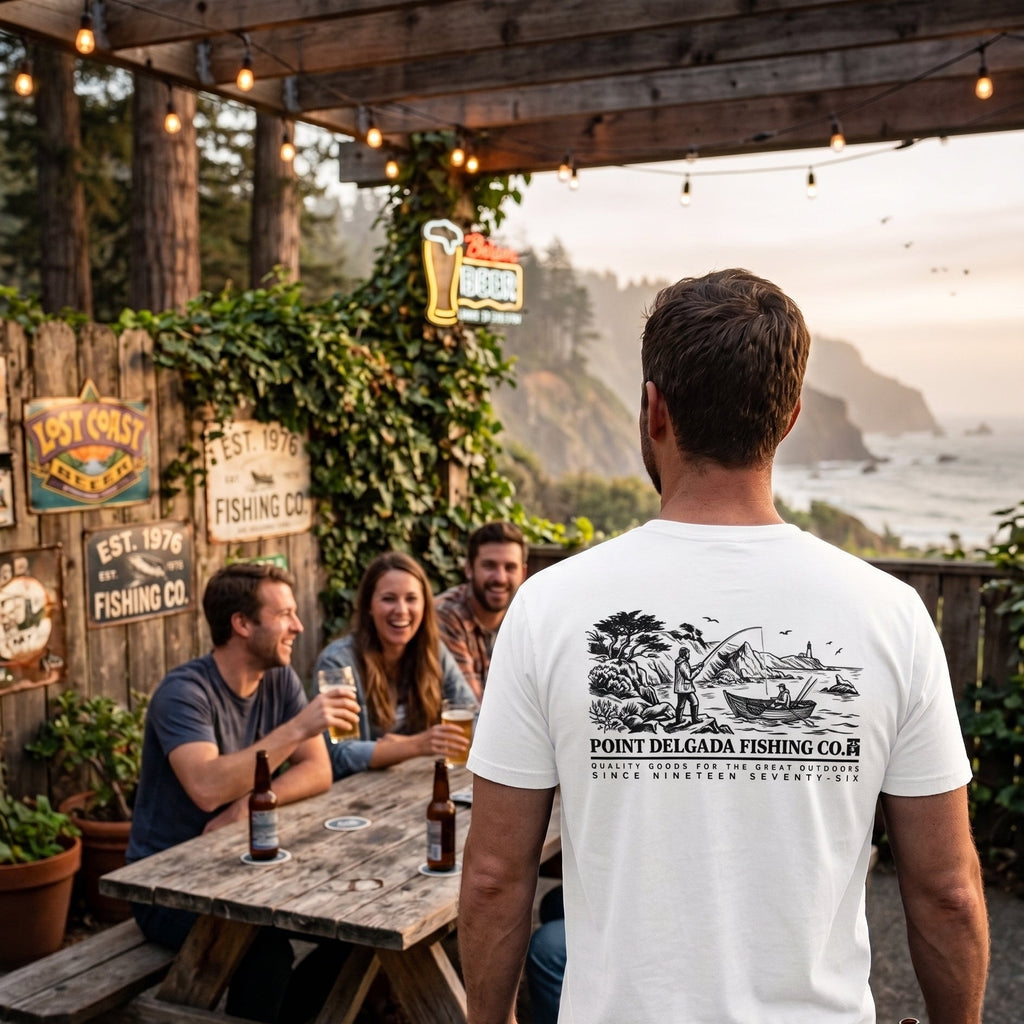 Point-Delgada-Fishing-Co-Heavyweight-6.1oz-Garment-Dyed-Graphic-Tee-Pitch-Black-Back-View showing the large archival illustration of Shelter Cove, a longliner crew at work near the lighthouse, and text "POINT DELGADA FISHING CO. SINCE NINETEEN SEVENTY-SIX".