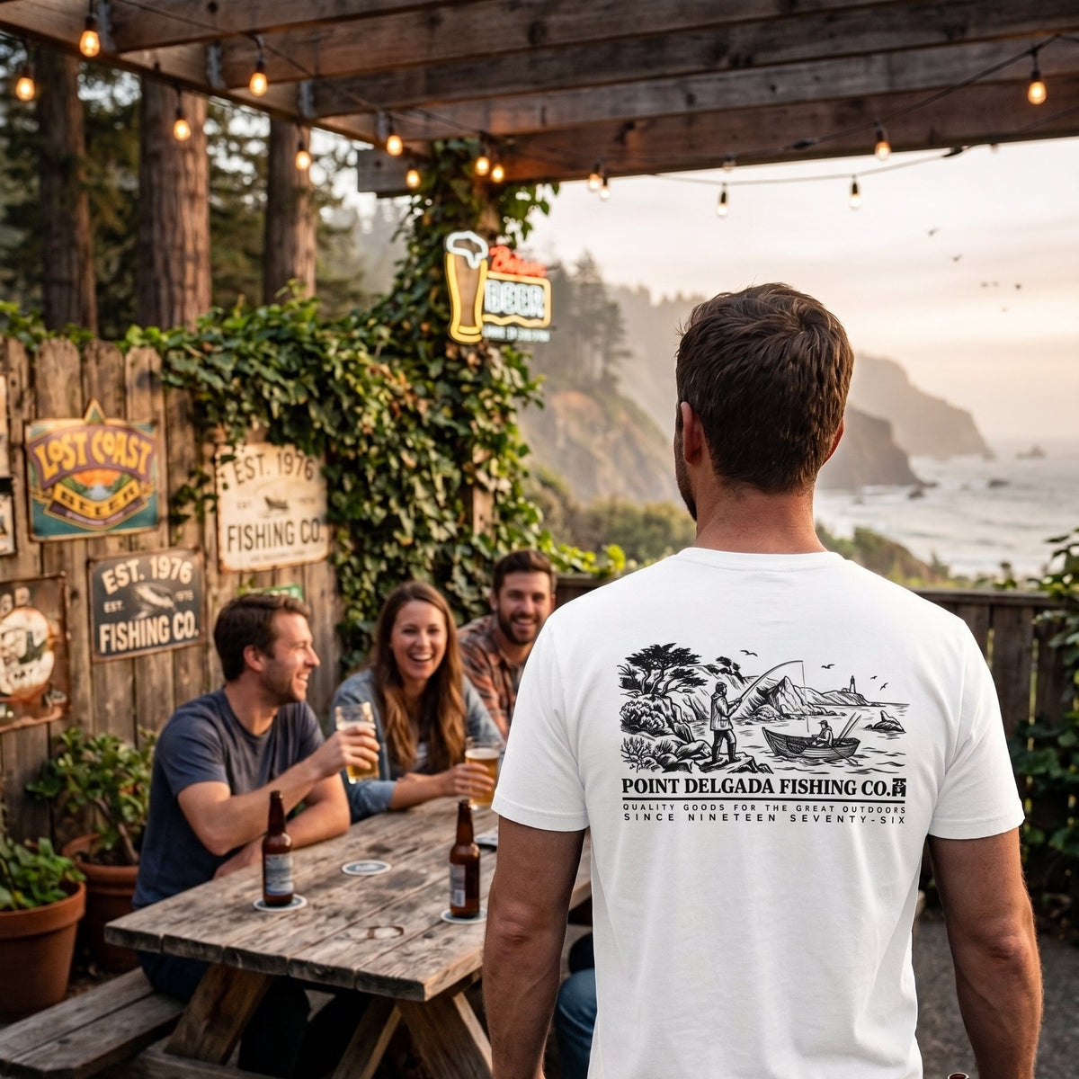 Point-Delgada-Fishing-Co-Heavyweight-6.1oz-Garment-Dyed-Graphic-Tee-Pitch-Black-Back-View showing the large archival illustration of Shelter Cove, a longliner crew at work near the lighthouse, and text "POINT DELGADA FISHING CO. SINCE NINETEEN SEVENTY-SIX".